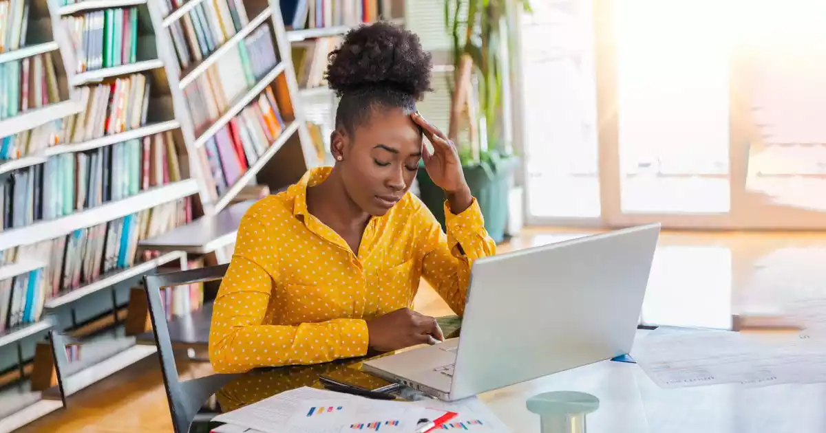 Black person stressed in office - The BeniTalk